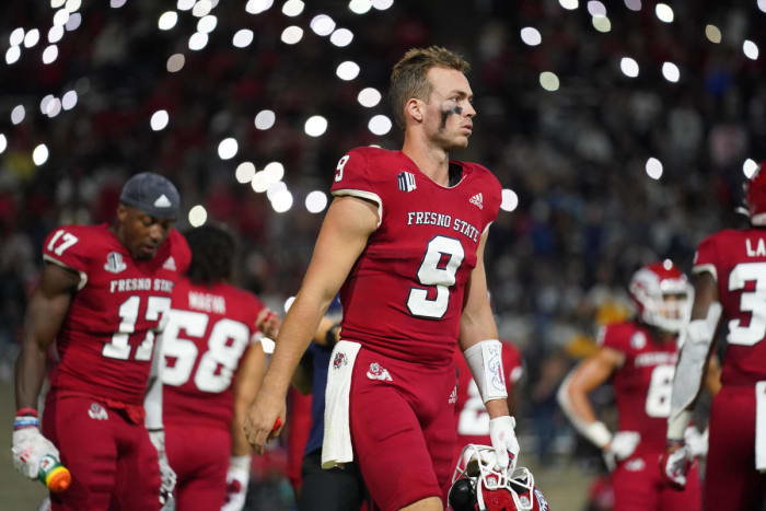 Jake Haener (9) walks on the field before the start of the fourth quarter